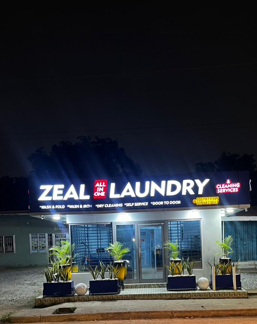 Zeal Laundry storefront at night
